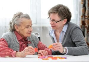 A mother and daughter completing a puzzle togeather in an effort to help with memory and retention