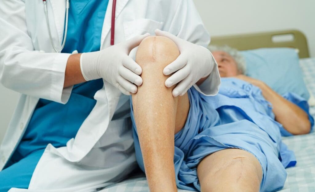 Lady on hospital bed after surgery, with doctor